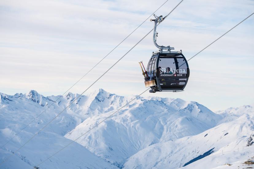 Gondola in Swiss mountains of Andermatt ski reosrt transporting skiers to top of mountain
